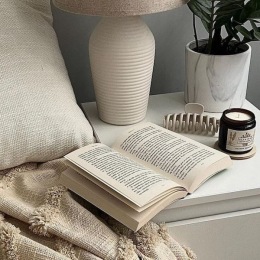 a bed with an open book