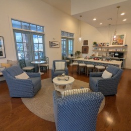 a clubroom with tables and chairs