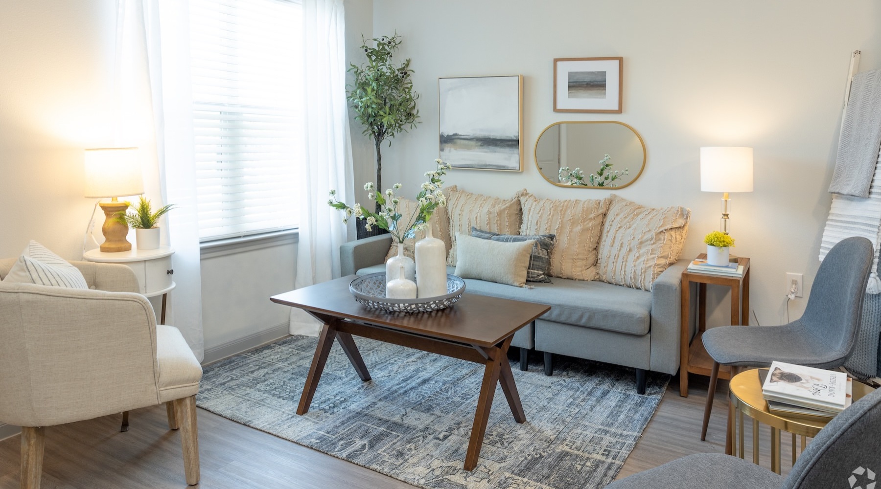 a living room with a couch, coffee table and chairs