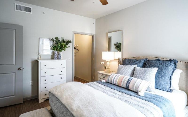 a bedroom with a bed and a dresser