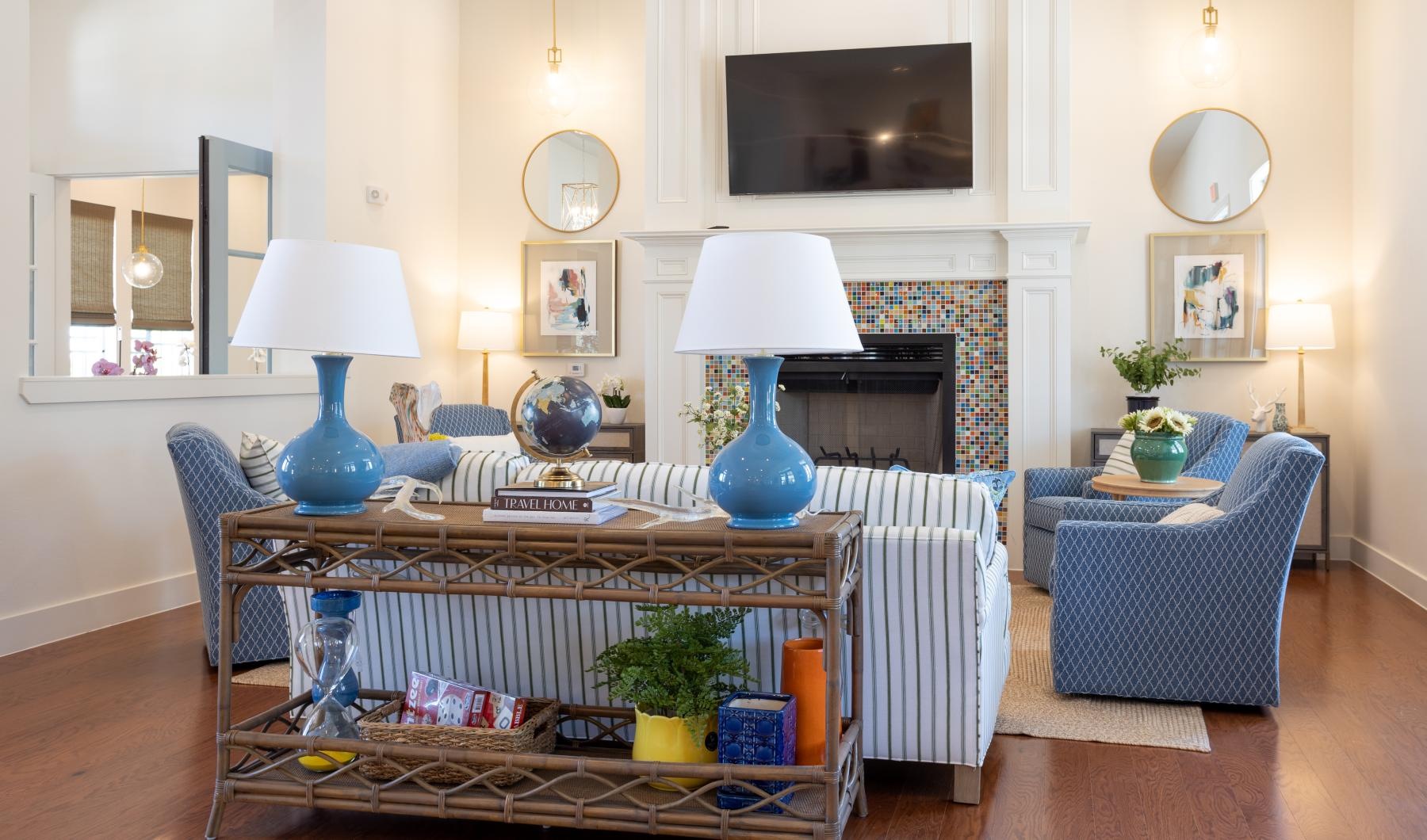 a clubroom with a tv, couch and chairs
