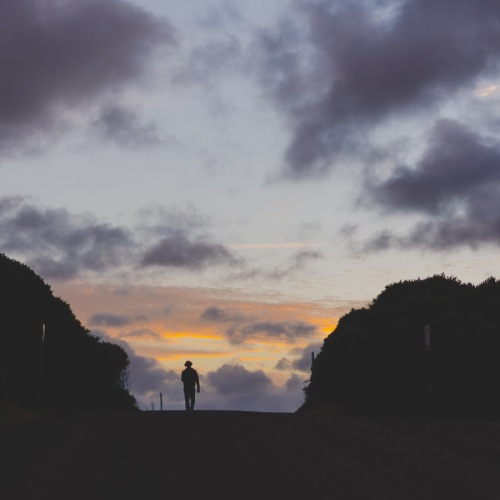 a person walking through a valley at night